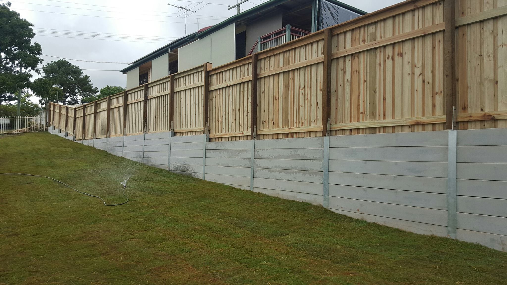 Durawall staggered retaining wall and timber fence