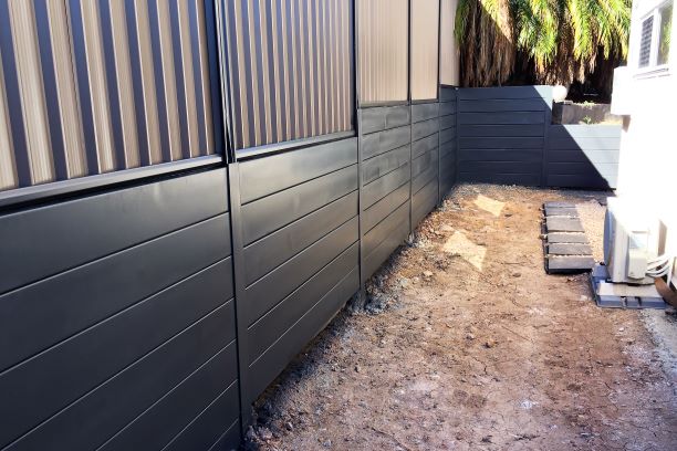 Durawall retaining wall sealed in monument with colorbond fence in Slacks Creek after photo
