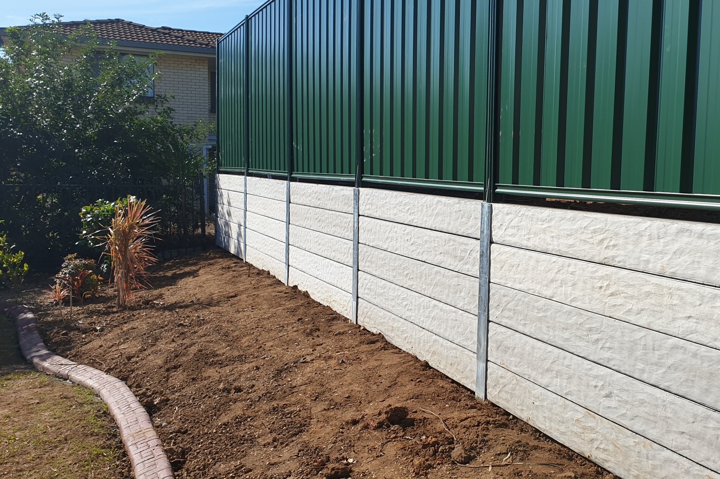 Durawall retaining wall replacement at Robertson after photo of granite stone sleepers and Colorbond fence